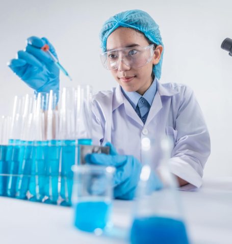 A female scientist using lab equipment for research in a modern laboratory setting.